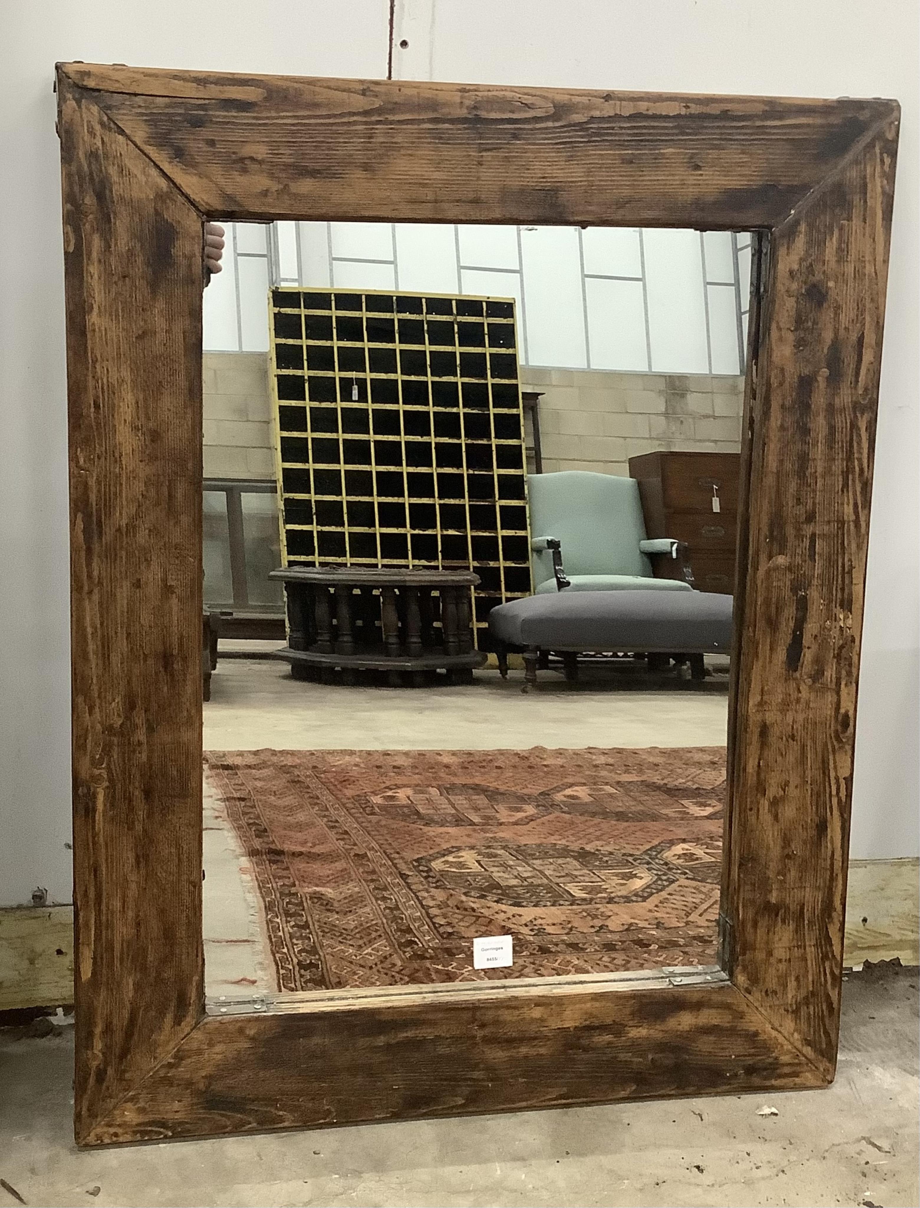 An Indian rectangular carved hardwood wall mirror, width 88cm, height 160cm and a smaller rectangular pine wall mirror (2). Condition - fair